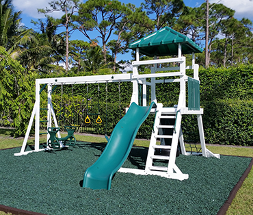 Large Swing Kingdom vinyl playsetinstalled by Play King with custom rubber mulch installed.