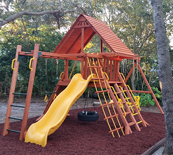 Images of installed wood and vinyl playsets